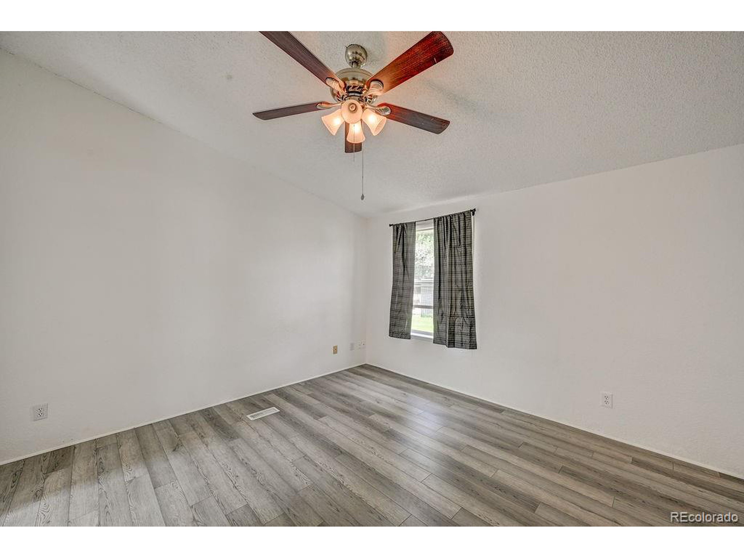 121 Brookdale Avenue Buena Vista, CO 81211 - Photo 31 of 50 a view of an empty room with wooden floor and a window
