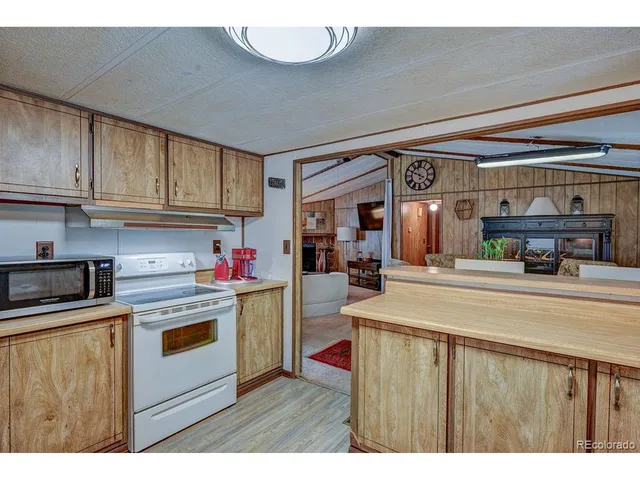 a kitchen with kitchen island a stove a sink and a refrigerator