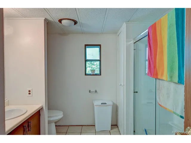 a bathroom with a toilet sink and shower