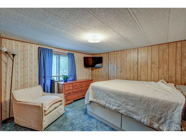 a living room with a bed window and a dresser