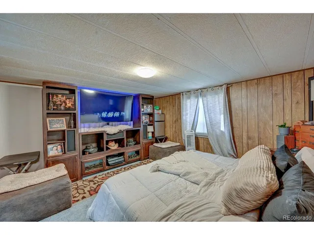 a bedroom with furniture and a flat screen tv