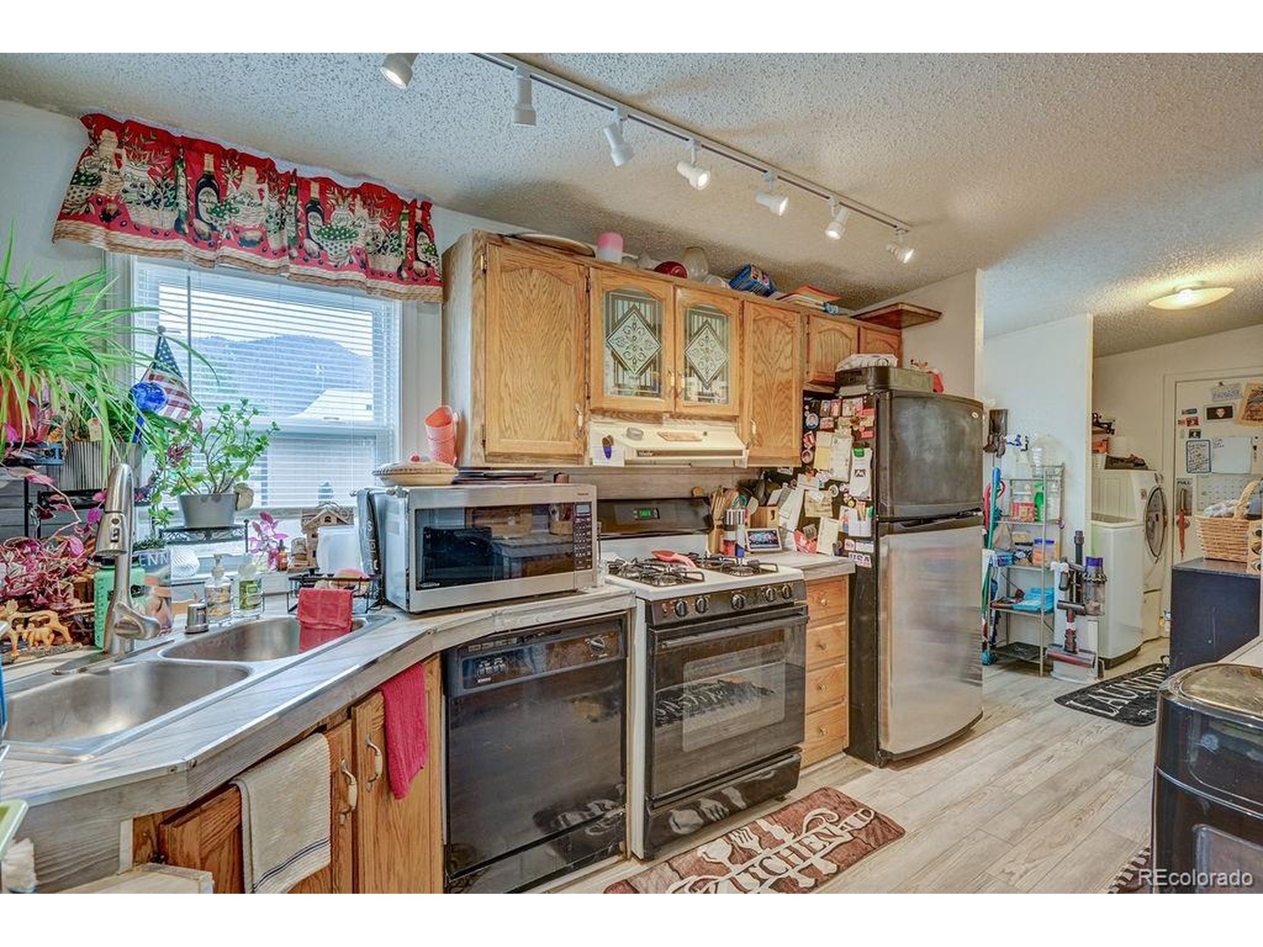 121 Brookdale Avenue Buena Vista, CO 81211 - Photo 5 of 50 a kitchen with stainless steel appliances kitchen island granite countertop a sink and cabinets