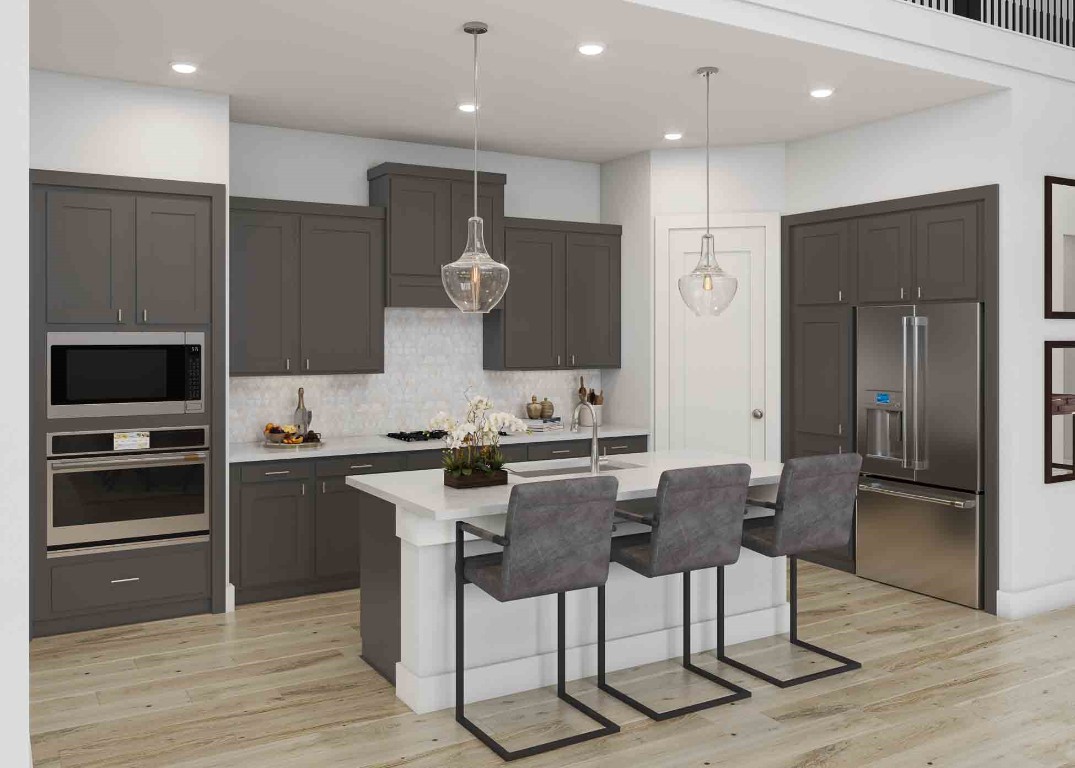 7926 Antler Rdg Drive Fulshear, TX 77441 - Photo 2 of 11 a kitchen with stainless steel appliances kitchen island granite countertop a refrigerator and a stove top oven