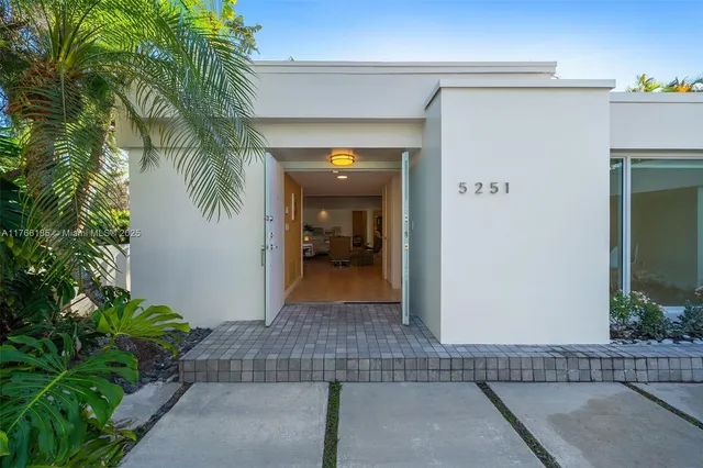 a view of a hallway with potted plants