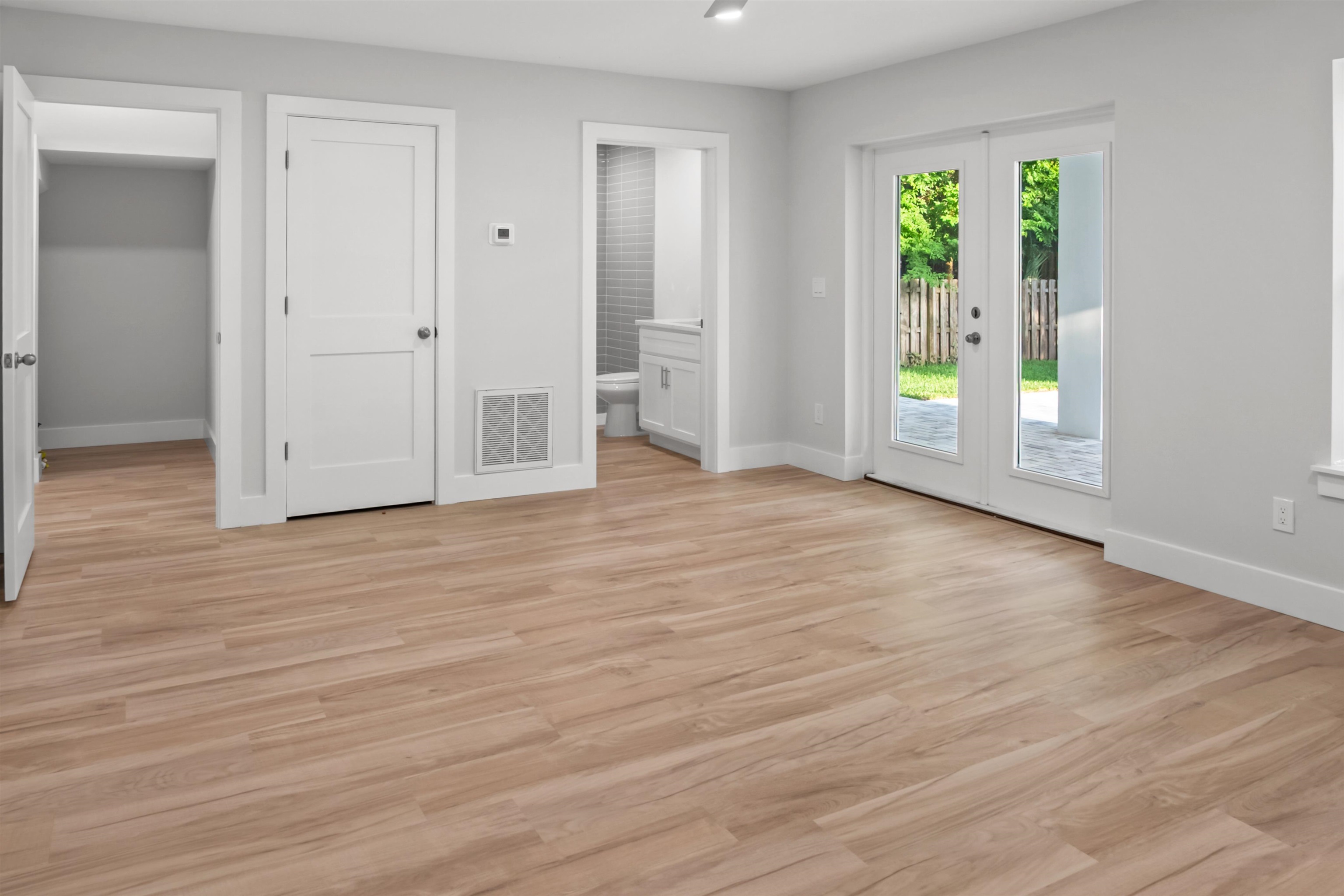 137 Ferrol Road St. Augustine, FL 32084 - Photo 22 of 53 an empty room with wooden floor and windows