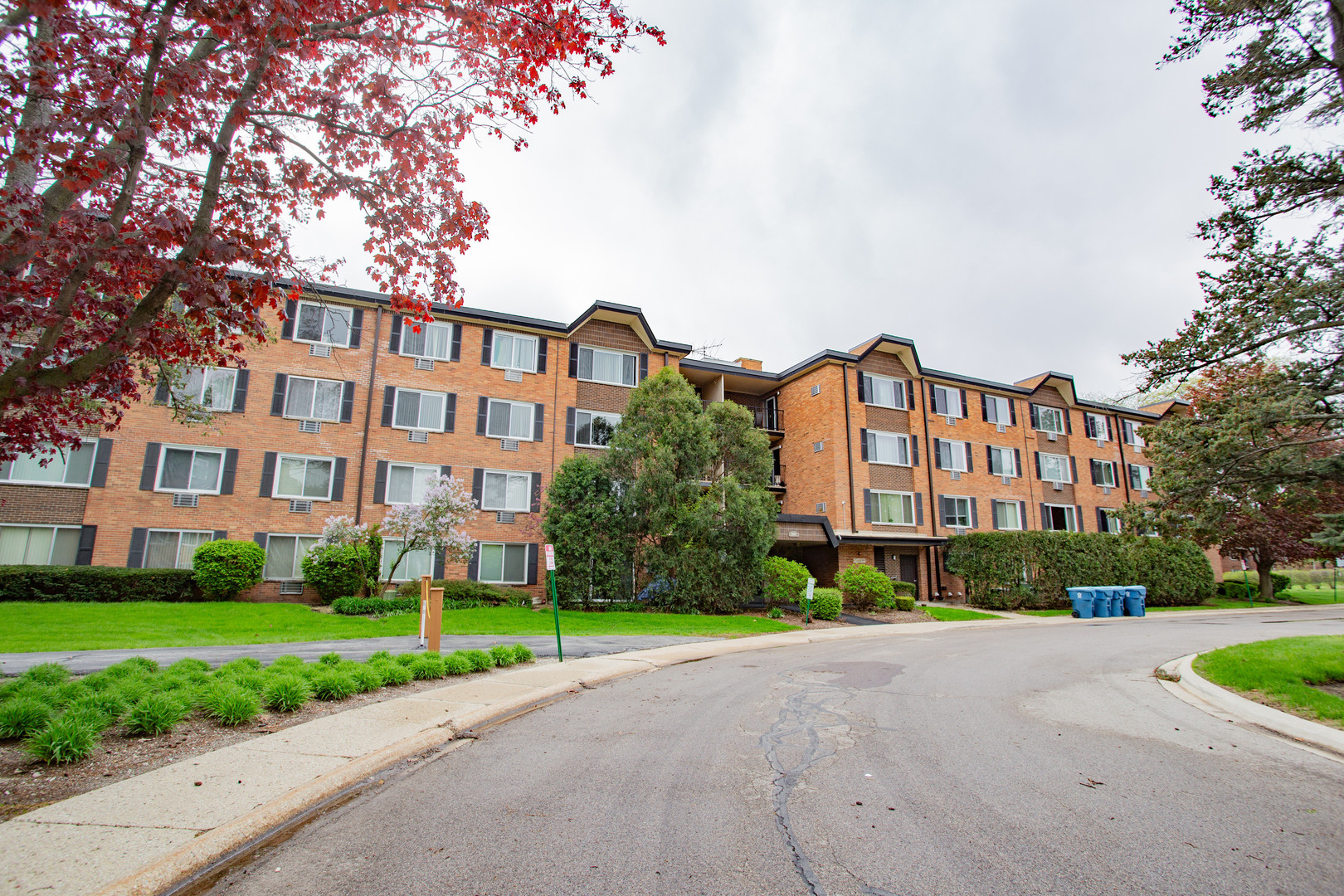 1217 South Old Wilke Road, Unit 201 Rolling Meadows, IL 60005 - Photo 24 of 26 a view of a building with a yard