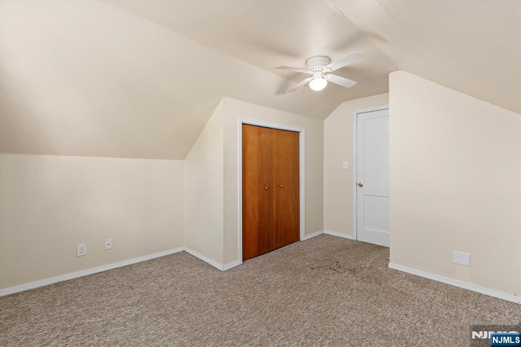 62 Johnson Avenue Wallington, NJ 07057 - Photo 13 of 25 an empty room with closet and a chandelier fan