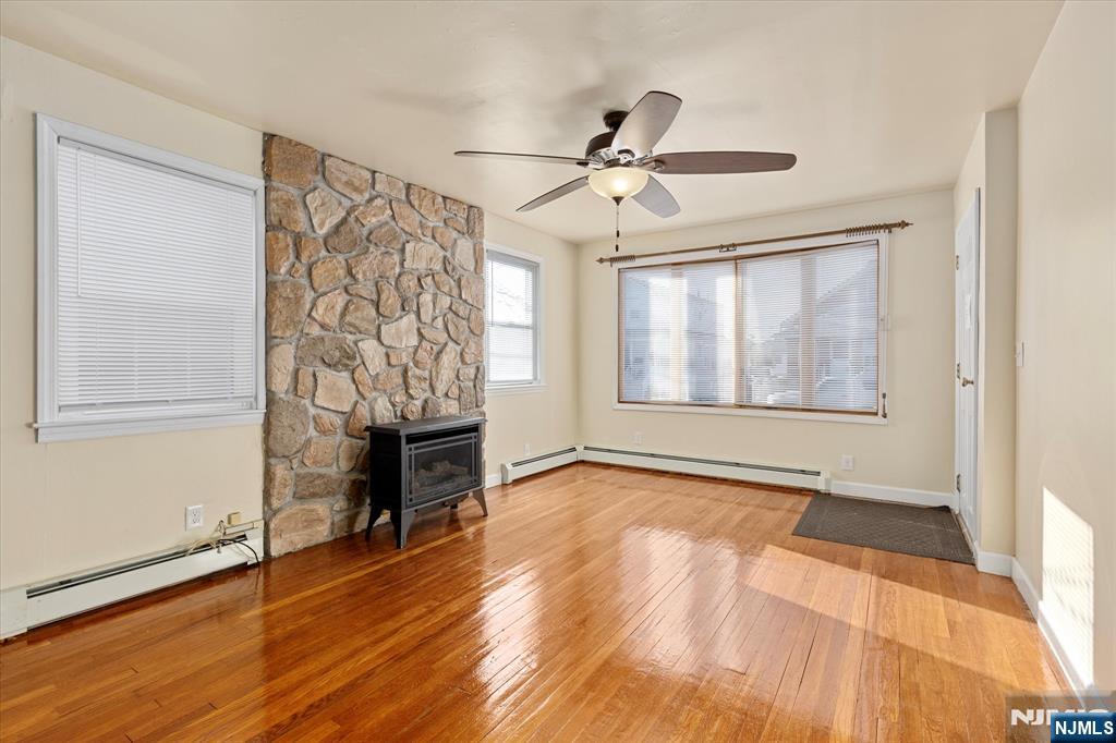 62 Johnson Avenue Wallington, NJ 07057 - Photo 3 of 25 a view of empty room with wooden floor and fan