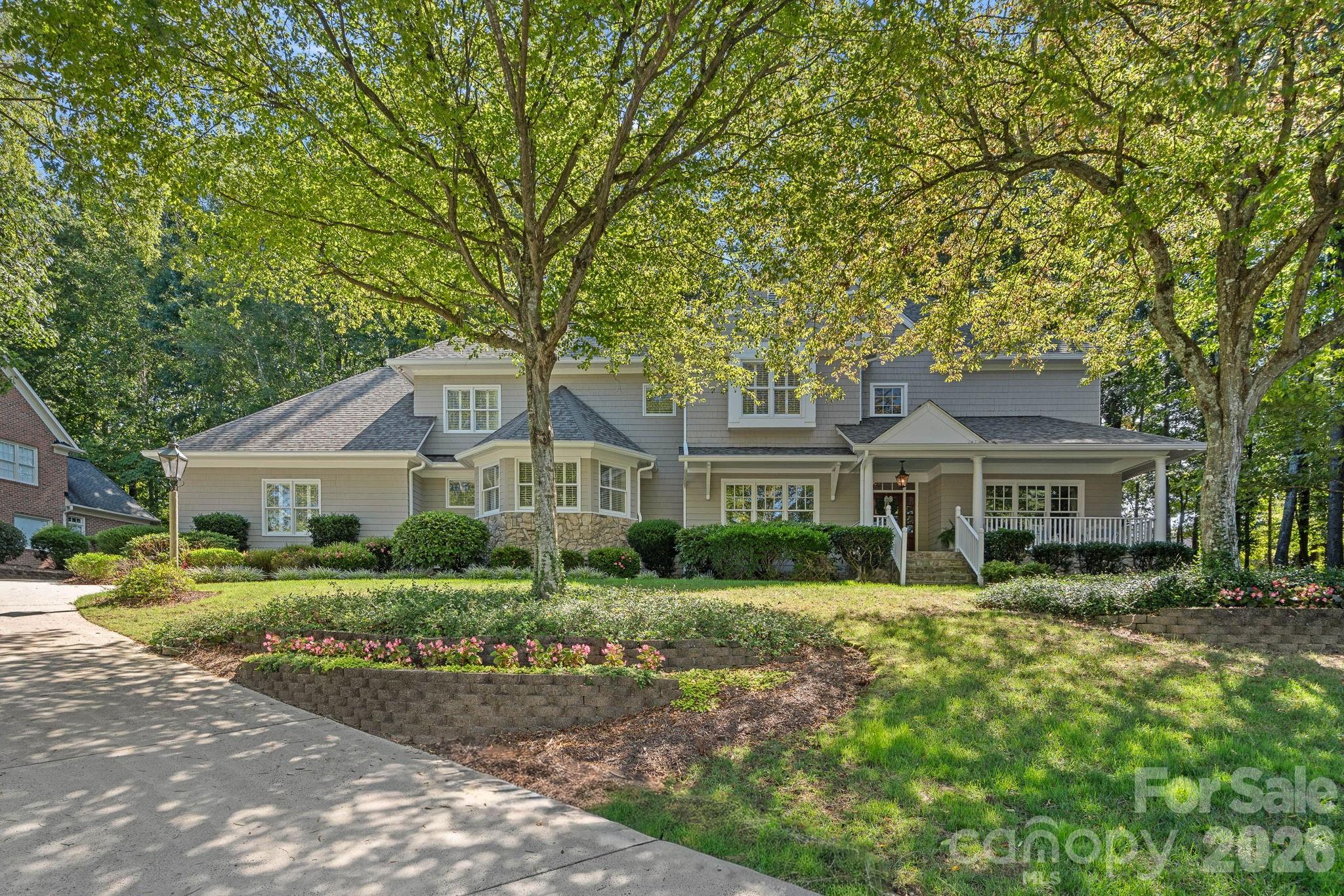 a front view of a house with a garden