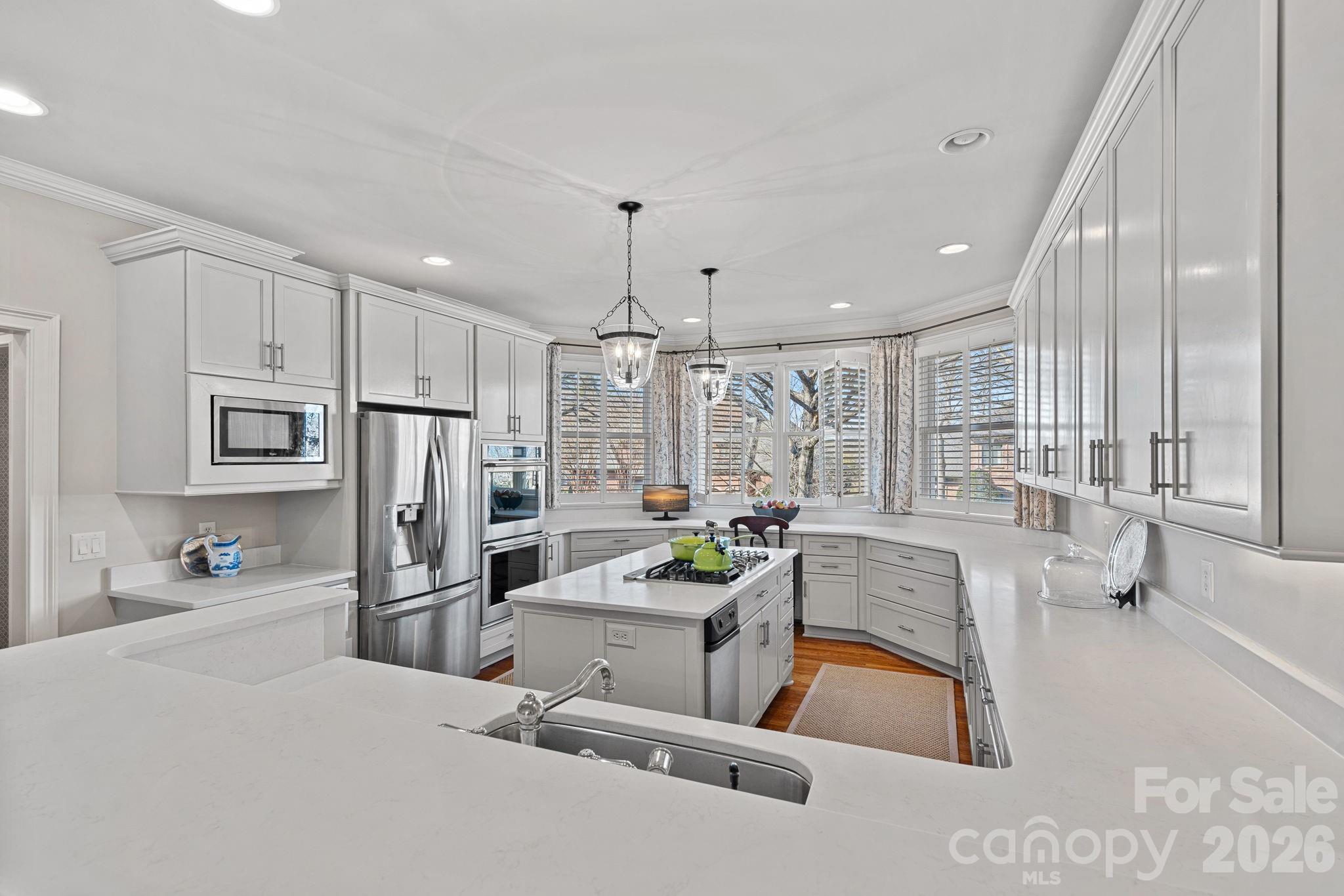 19016 Wildcat Trail Davidson, NC 28036 - Photo 16 of 48 a large white kitchen with a large window and stainless steel appliances