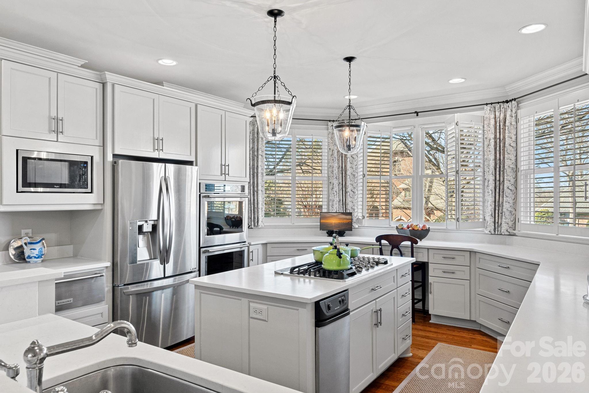 19016 Wildcat Trail Davidson, NC 28036 - Photo 18 of 48 a kitchen with stainless steel appliances a center island cabinets and a window