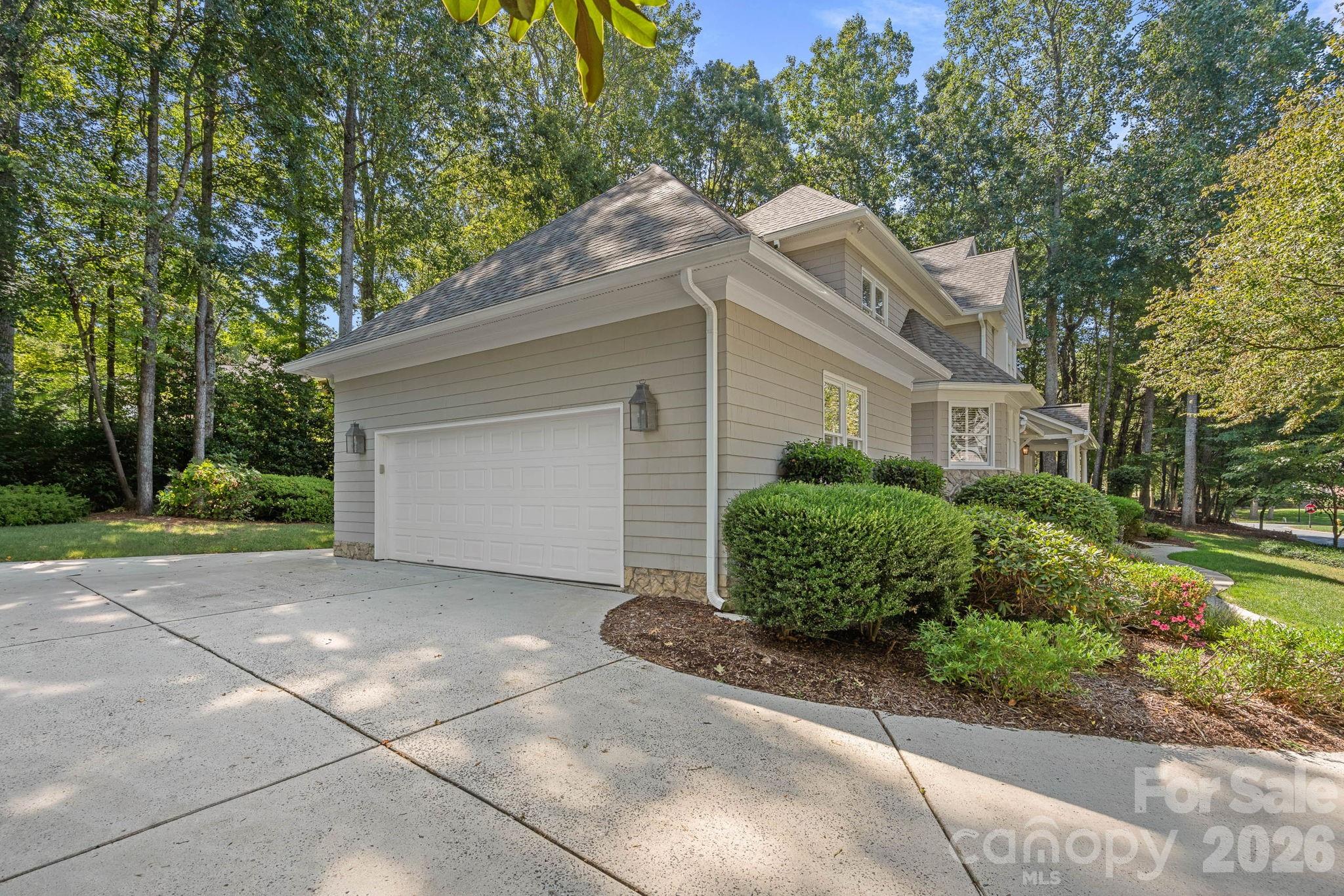 19016 Wildcat Trail Davidson, NC 28036 - Photo 42 of 48 a front view of a house with a garden