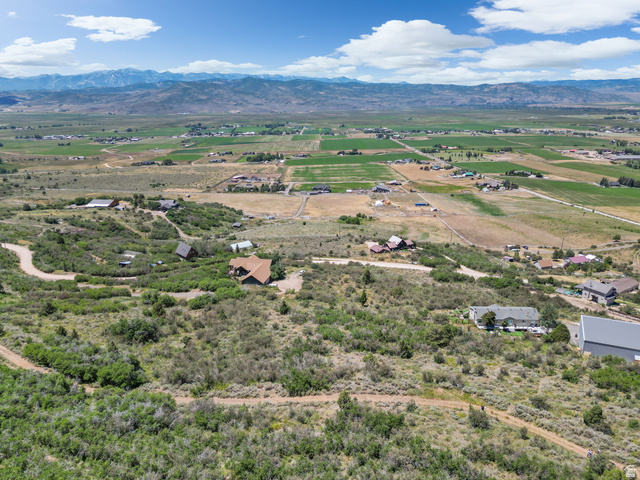 2459 Painter Road Marion, UT 84036 - Photo 35 of 42 Expansive rural landscape featuring scattered residential properties, distant agricultural fields, and a prominent mountain range