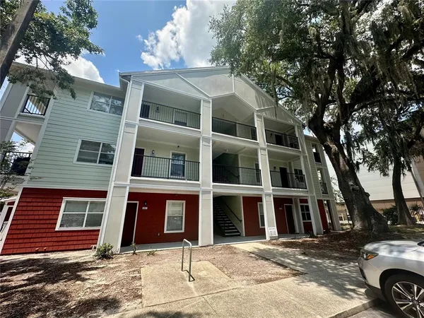 a front view of a residential apartment building with a yard