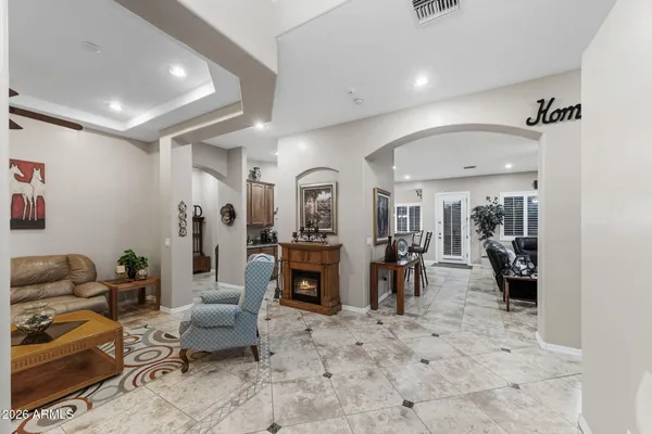 a living room with furniture and a large mirror