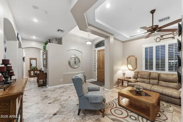 a living room with furniture a fireplace and a large window