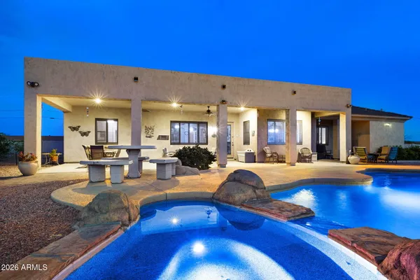 a view of a living room with kitchen island furniture and a swimming pool