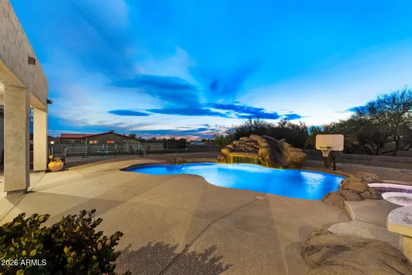 a view of a swimming pool with an outdoor seating and a yard
