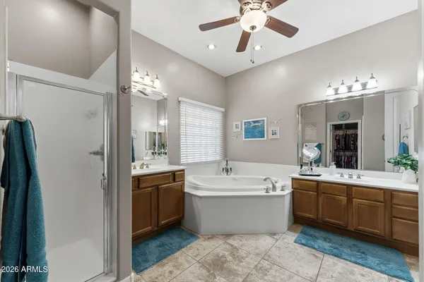 a large bathroom with a large tub and sink