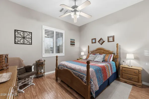 a bedroom with a bed and a chair