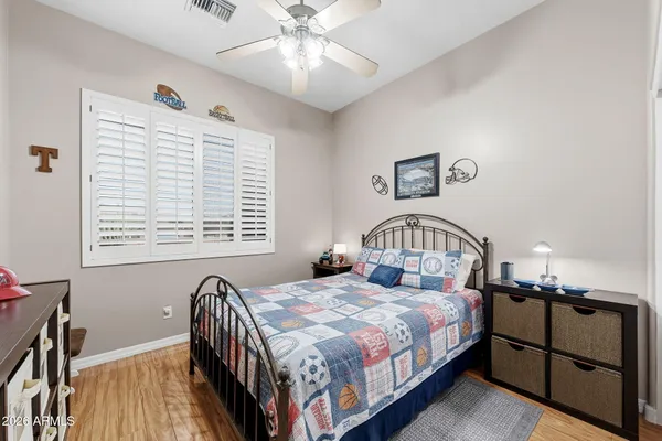 a bedroom with a large bed and a chandelier
