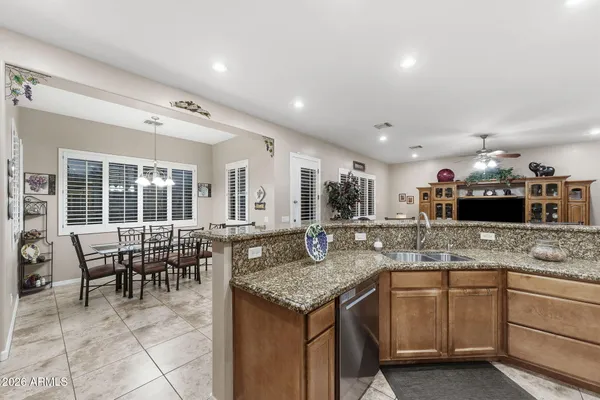 a kitchen with granite countertop sink table and chairs