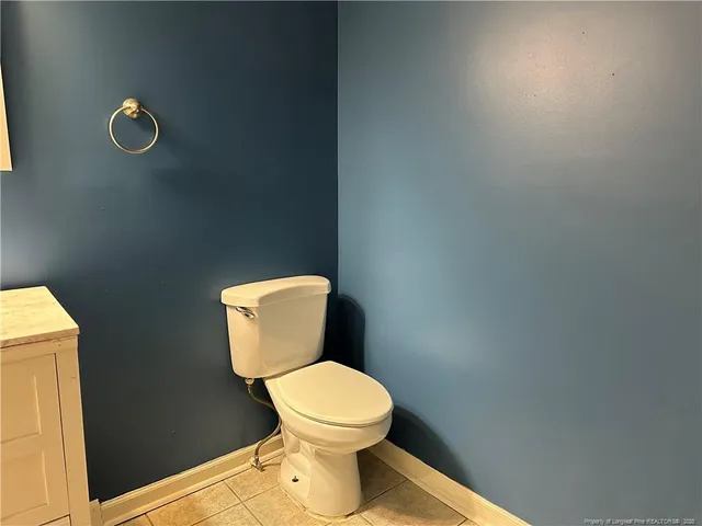 a white toilet sitting next to a shower