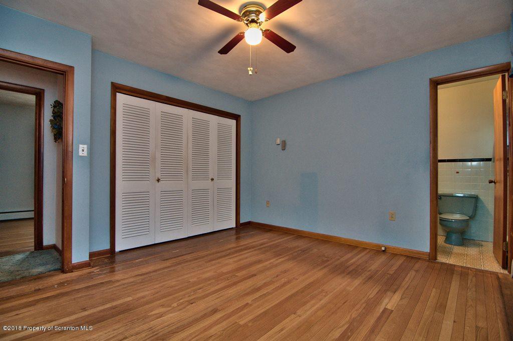 1073 Mt Cobb Road Lake Ariel, PA 18436 - Photo 11 of 22 an empty room with wooden floor and door