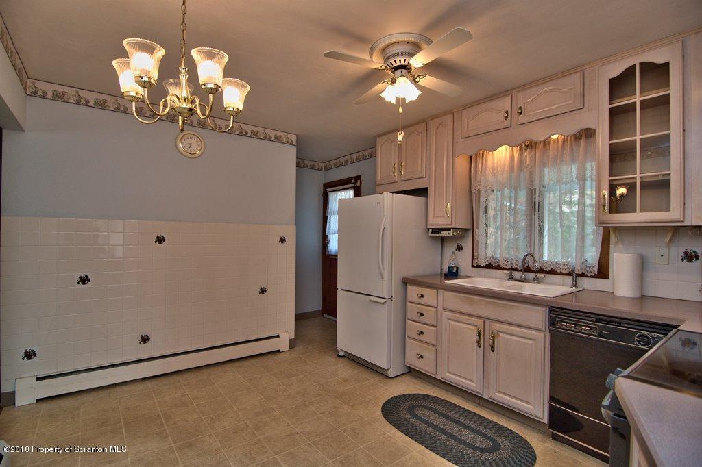 1073 Mt Cobb Road Lake Ariel, PA 18436 - Photo 8 of 22 a kitchen that has a stove a sink and a chandelier