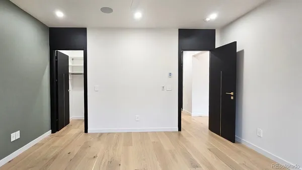 a view of hallway with a large window and wooden floor