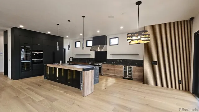 a kitchen with stainless steel appliances granite countertop a stove and a refrigerator