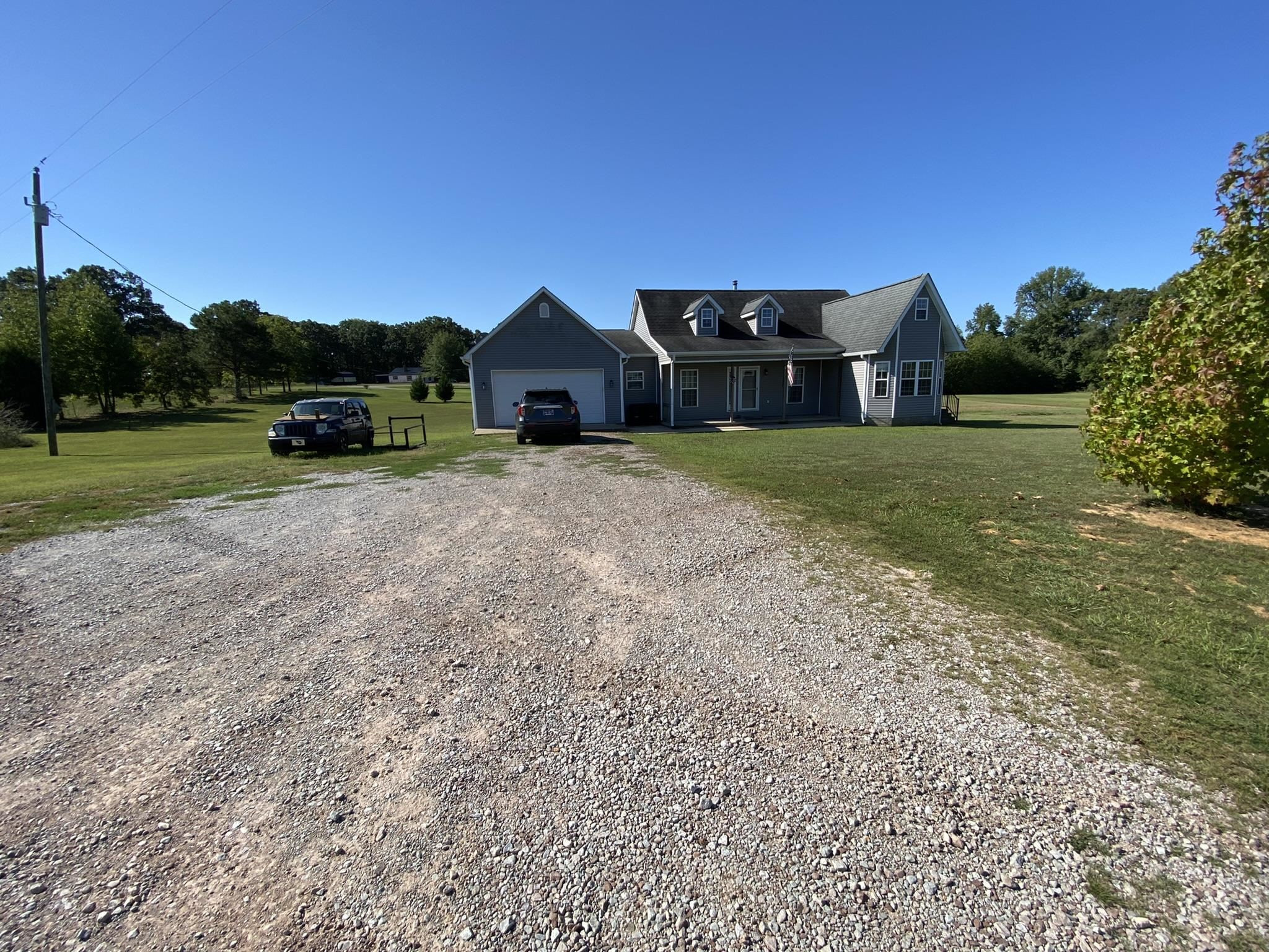 124 Milan Road Finger, TN 38334 - Photo 28 of 32 a front view of a house with a yard
