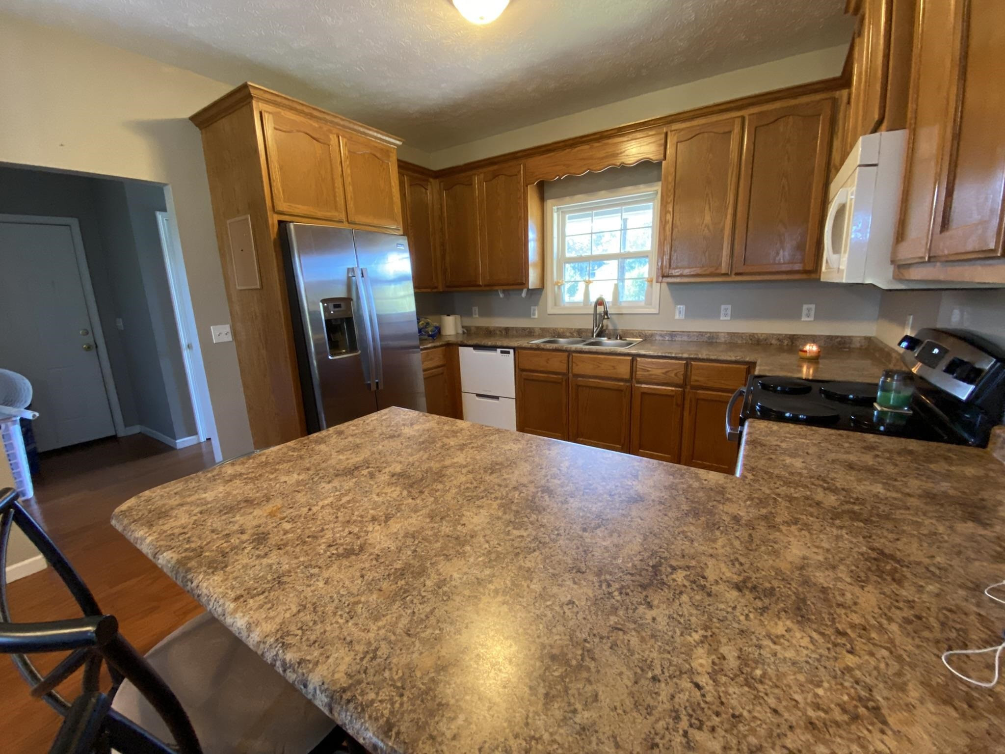 124 Milan Road Finger, TN 38334 - Photo 9 of 32 a kitchen with stainless steel appliances granite countertop a sink refrigerator and cabinets