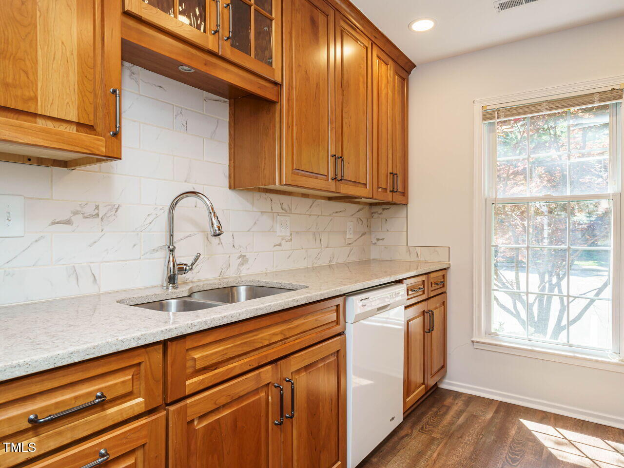 3125 Morningside Drive Raleigh, NC 27607 - Photo 11 of 26 a kitchen with stainless steel appliances granite countertop a sink and cabinets with wooden floor