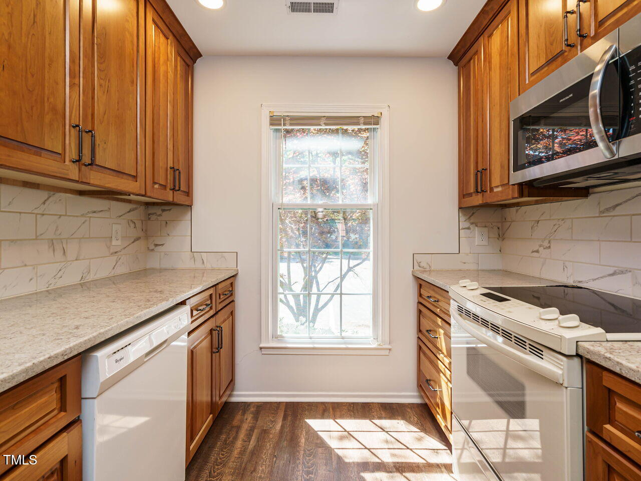 3125 Morningside Drive Raleigh, NC 27607 - Photo 13 of 26 a kitchen with stainless steel appliances granite countertop a stove a sink and a microwave