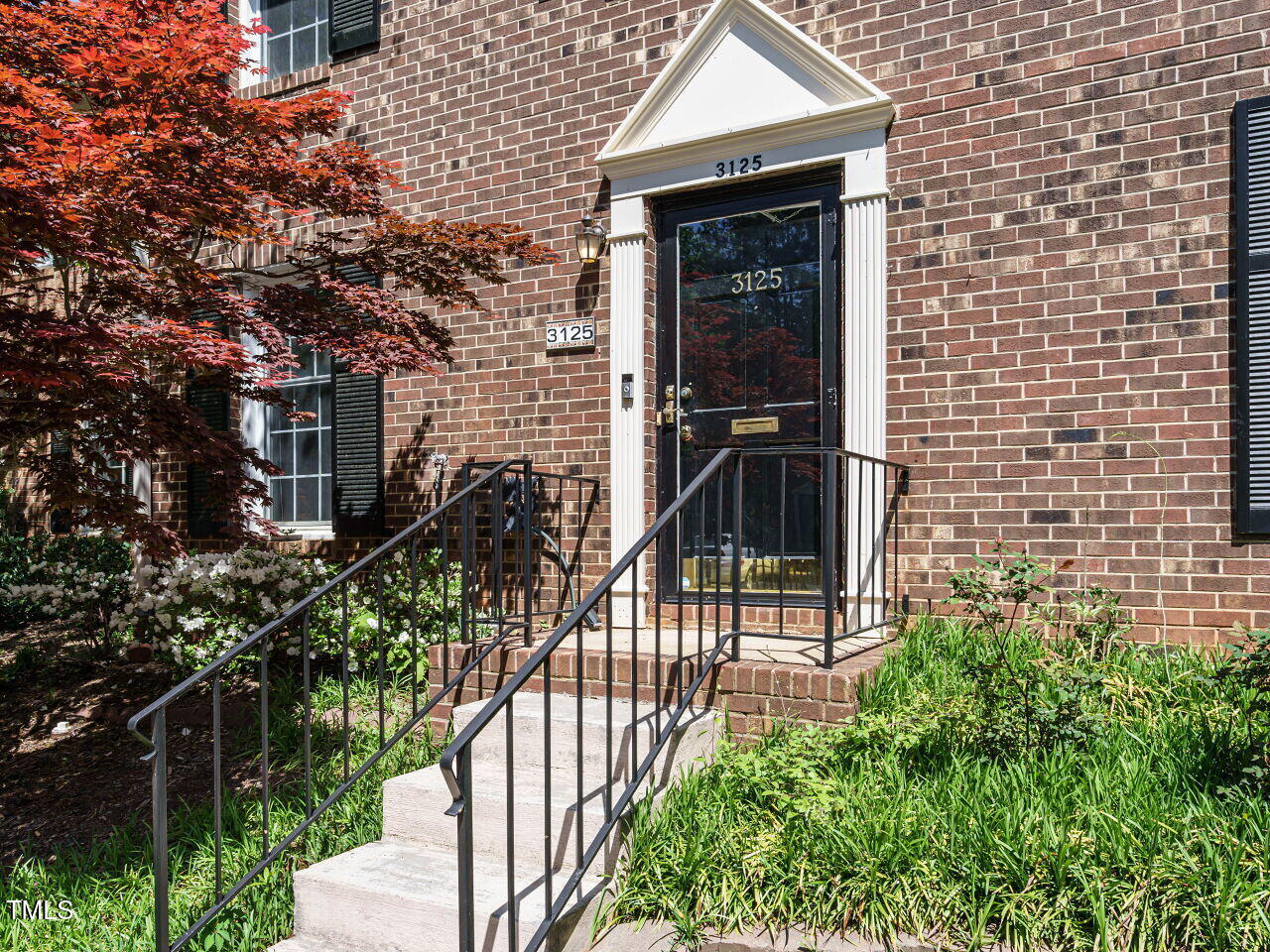 3125 Morningside Drive Raleigh, NC 27607 - Photo 3 of 26 a view of a brick house with plants and wooden fence