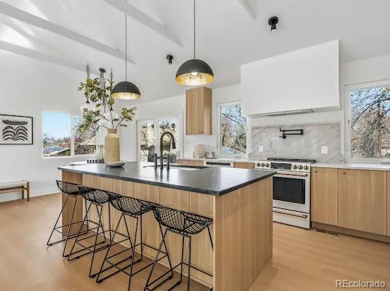 a kitchen with stainless steel appliances a sink and cabinets