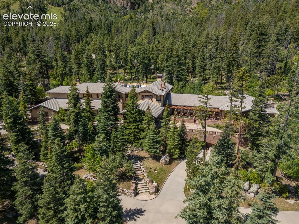 Arts and Craft style mountain lodge is the embodiment of western architecture & merges with the rugged landscape of Cheyenne Mountain