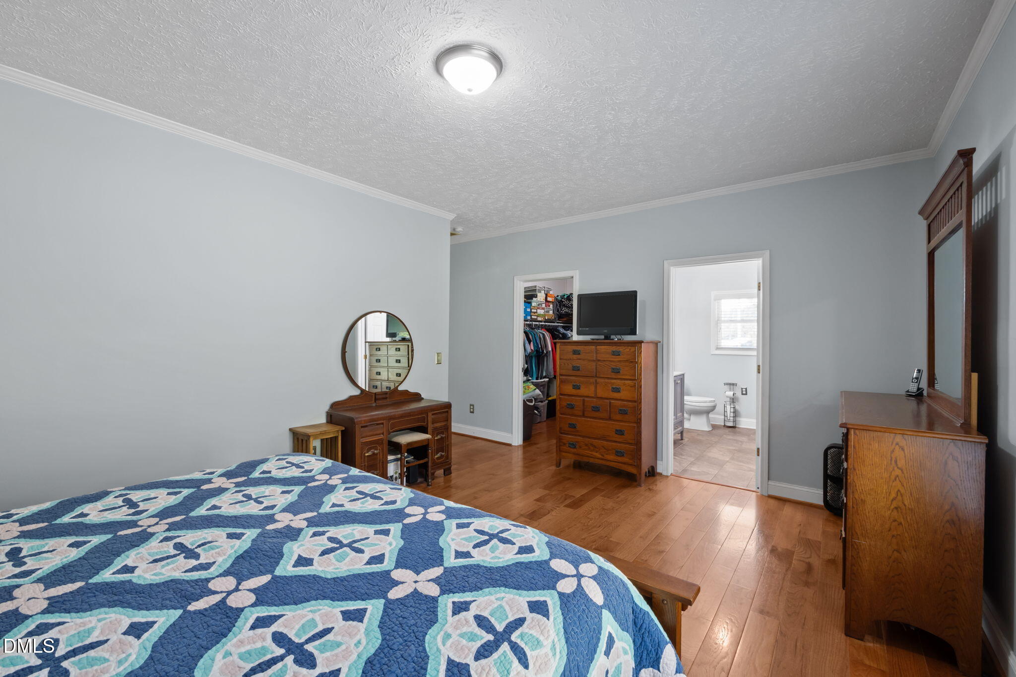 236 Dirgie Mine Road Roxboro, NC 27574 - Photo 33 of 55 a bedroom with bed and wooden floor