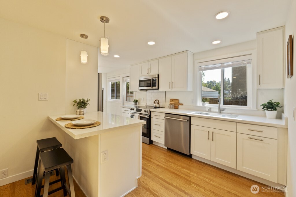 2646 34th Avenue West Seattle, WA 98199 - Photo 12 of 40 a kitchen with sink stove and refrigerator