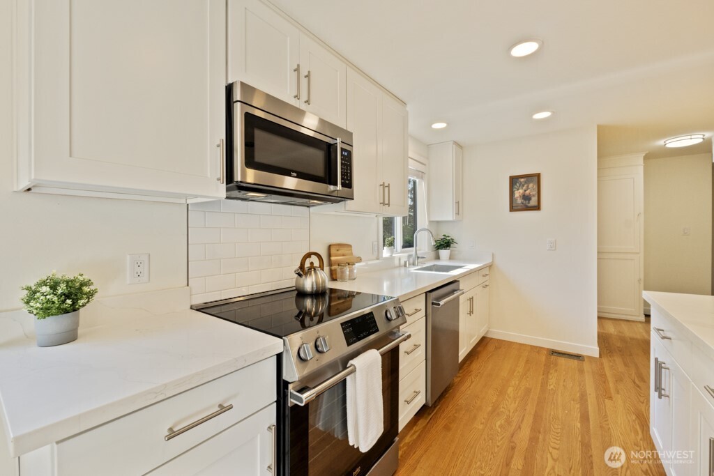 2646 34th Avenue West Seattle, WA 98199 - Photo 13 of 40 a kitchen with a sink stove and microwave