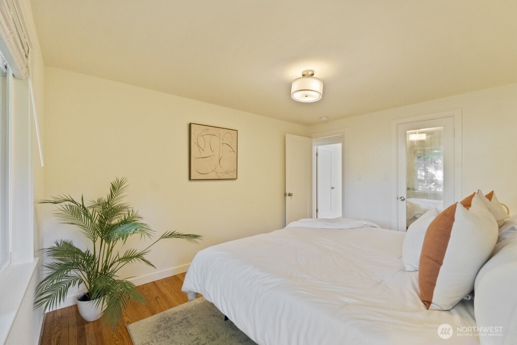 2646 34th Avenue West Seattle, WA 98199 - Photo 17 of 40 a bedroom with a bed and a potted plant