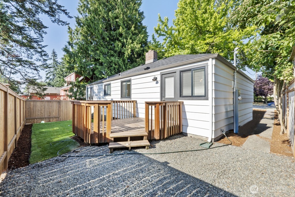 2646 34th Avenue West Seattle, WA 98199 - Photo 30 of 40 a view of a house with a small yard and wooden fence