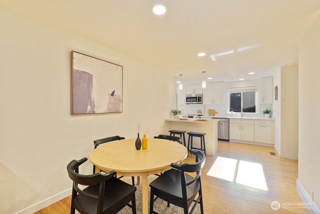 2646 34th Avenue West Seattle, WA 98199 - Photo 10 of 40 a view of a dining room with furniture and wooden floor