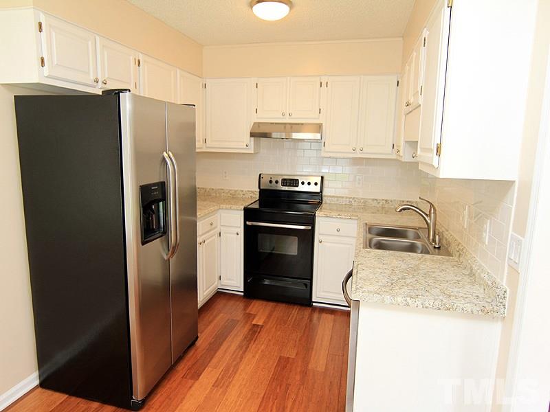 6705 Tattershale Court Raleigh, NC 27613 - Photo 2 of 13 New stainless steel appliances, real bamboo flooring, countertops, subway tile backsplash and paint.
