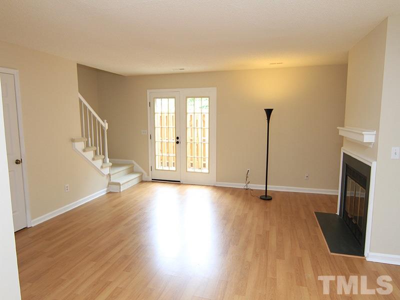 6705 Tattershale Court Raleigh, NC 27613 - Photo 5 of 13 Open living dining area with access via French doors to the private, fenced patio beyond.