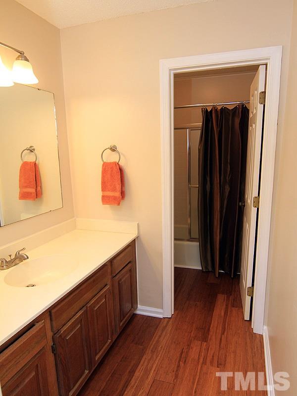 6705 Tattershale Court Raleigh, NC 27613 - Photo 9 of 13 Master Bath with separate vanity, new faucet, bamboo flooring and new comfort height toilet.