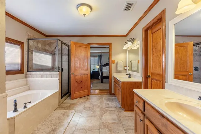 a bedroom with a large bed and a chandelier