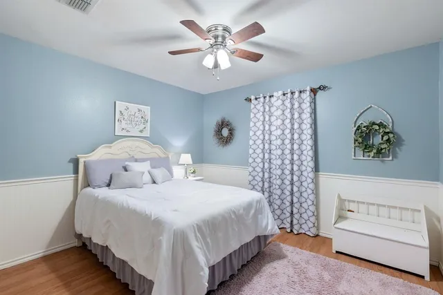 a bedroom with a bed and a chandelier