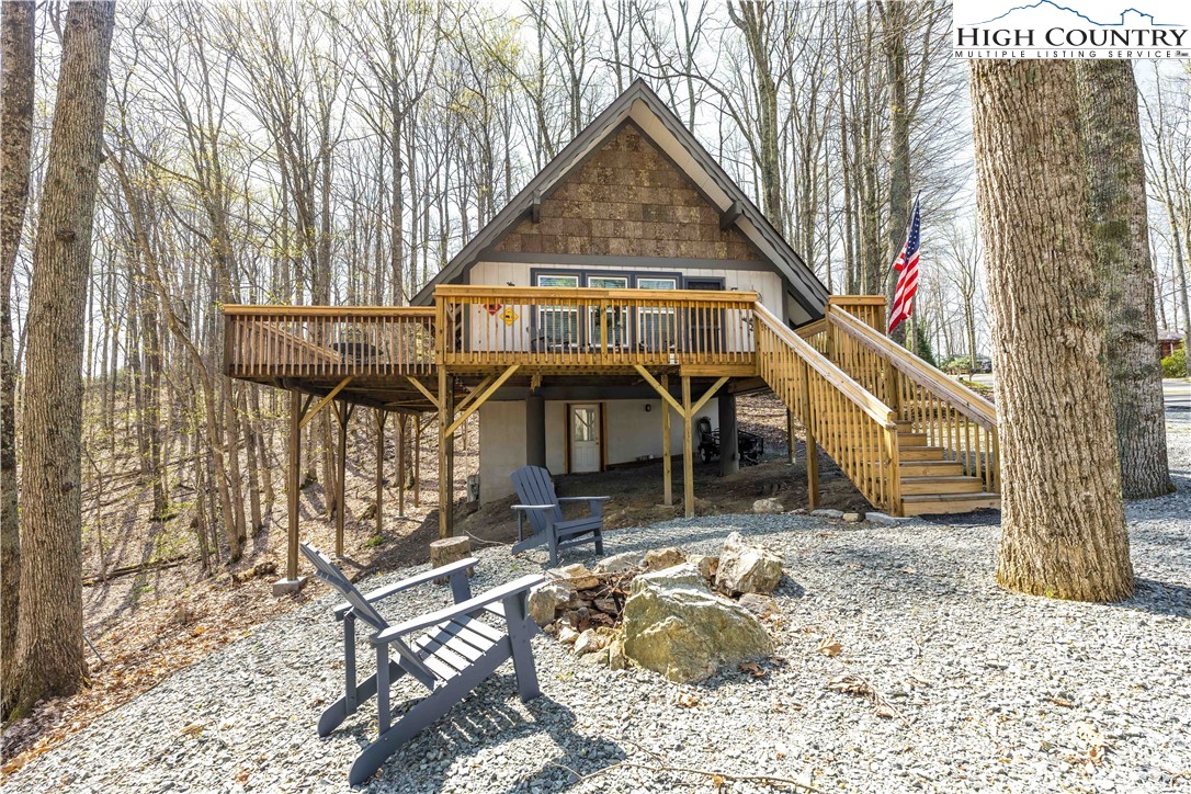 902 Pine Ridge Road Beech Mountain, NC 28604 - Photo 1 of 24 a front view of a house with parking area